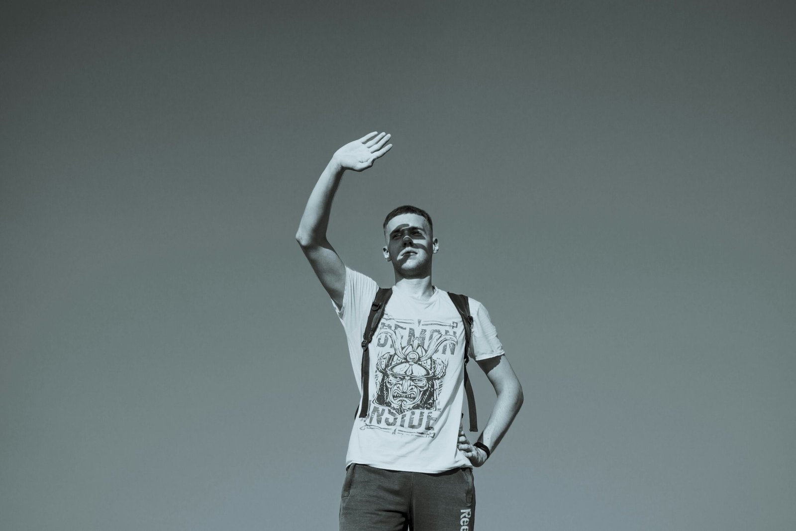 A man standing on top of a hill holding a frisbee